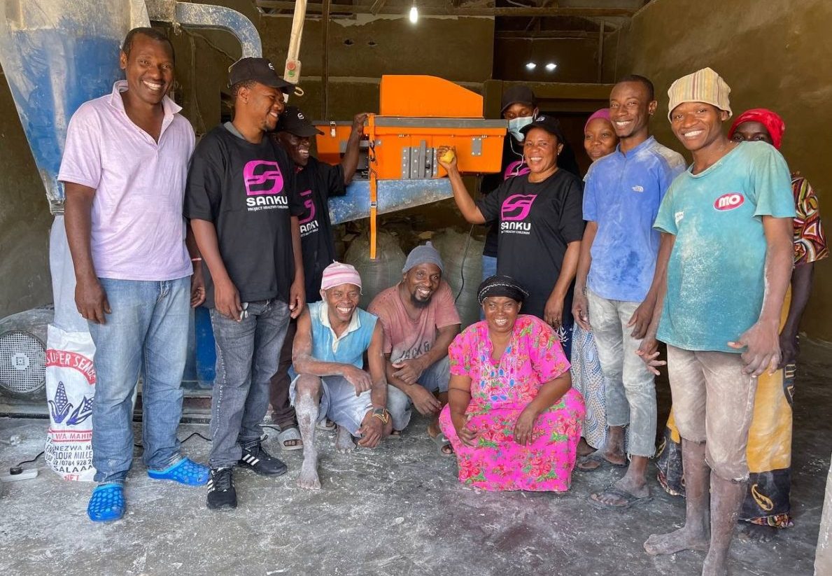 A group of millers around a dosifier. Photo Credit: Sanku